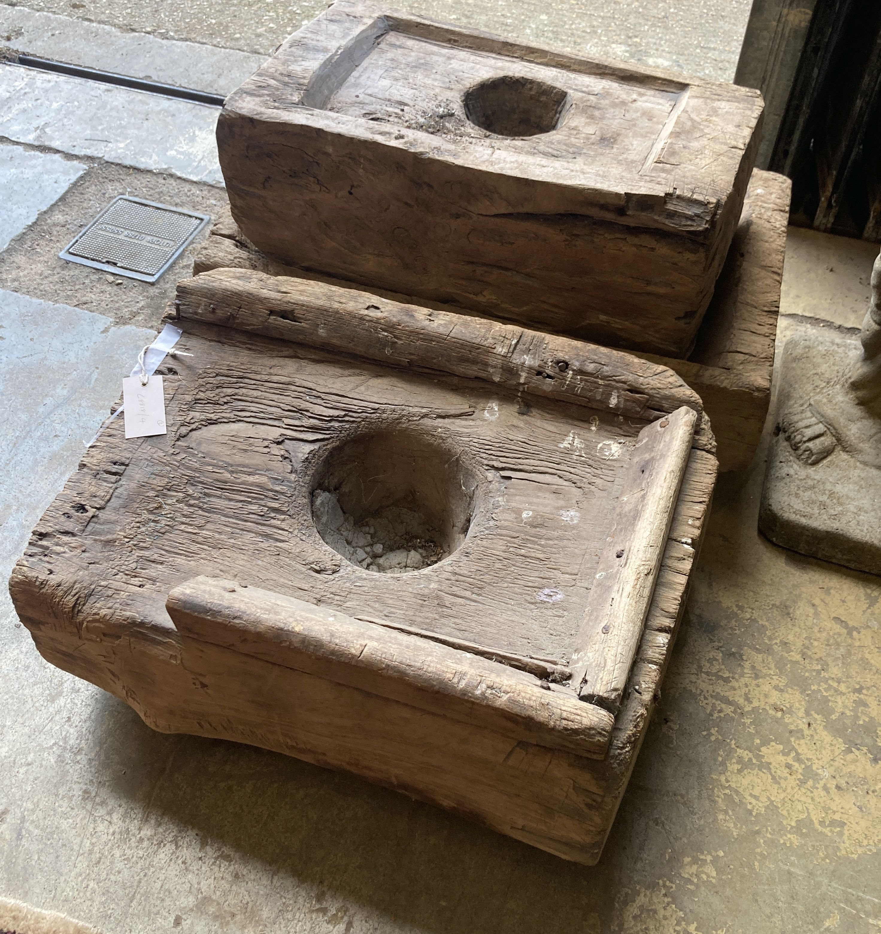 Three Indonesian hardwood rice mortars, largest 60cm, depth 38cm, height 23cm